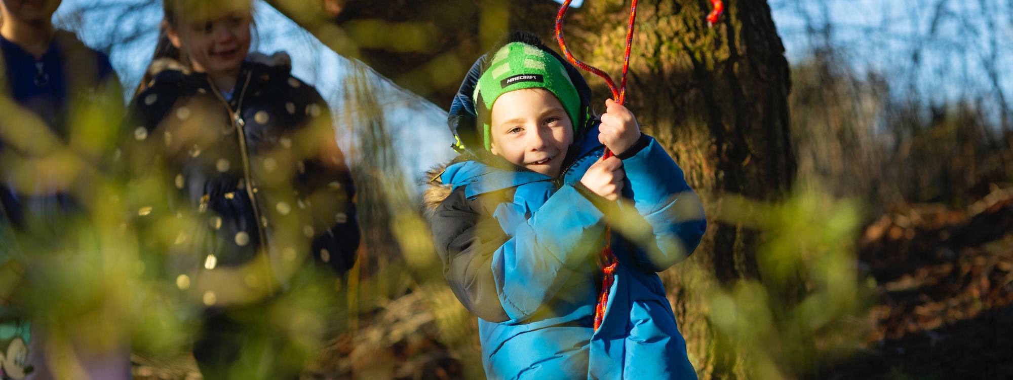 Lickey Hills School pupil on outside rope swing in trees