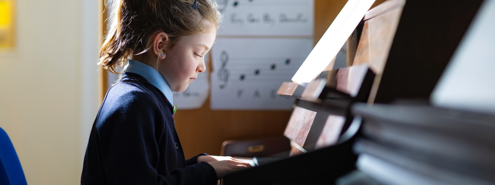 Lickey Hills School pupil concentrating on playing the piano