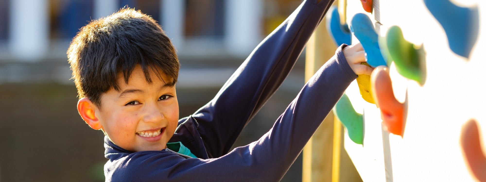 Lickey Hills School pupil outside on climbing wall